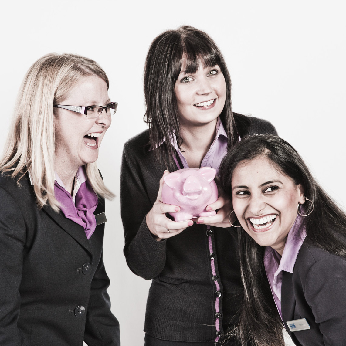 Three laughing women in uniform