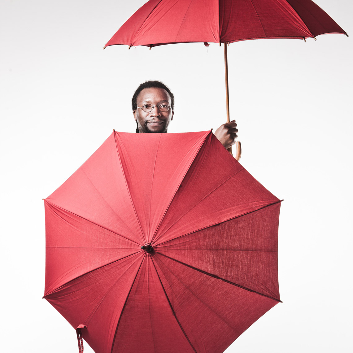 Black man with red umbrellas