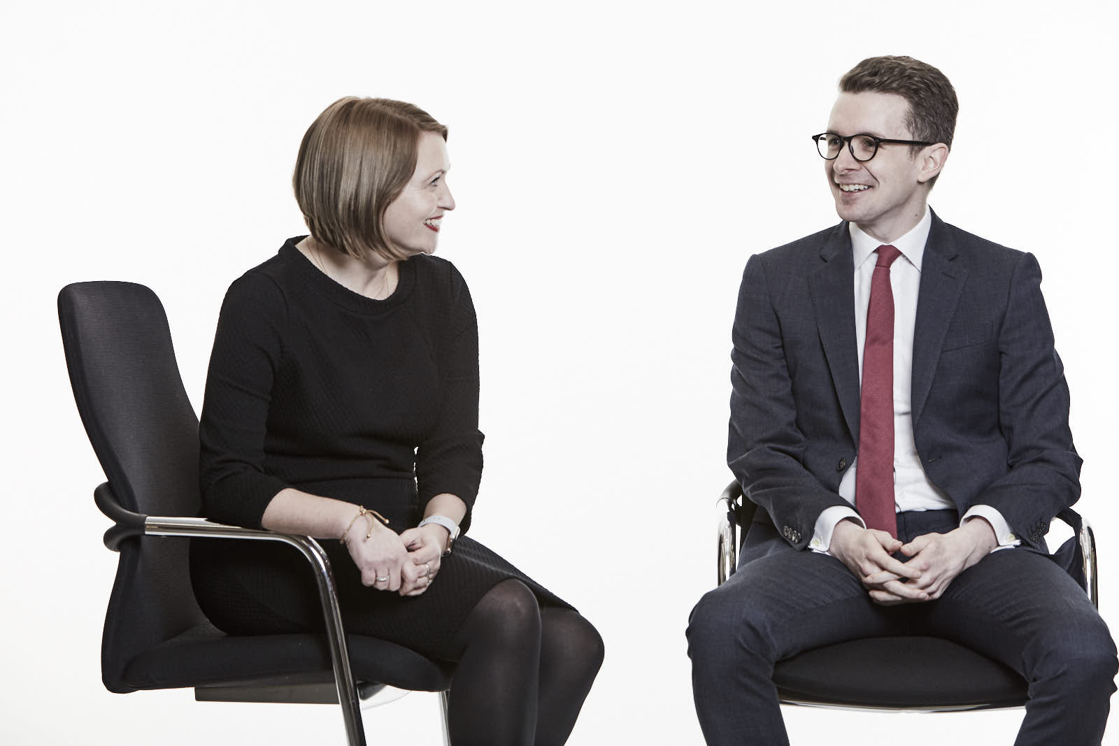 Expressive executive man and woman talking